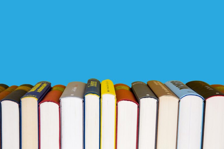 A row of books with a blue background to illustrate the Favorite Authors button.